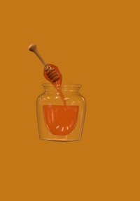a jar of honey with a spoon in it